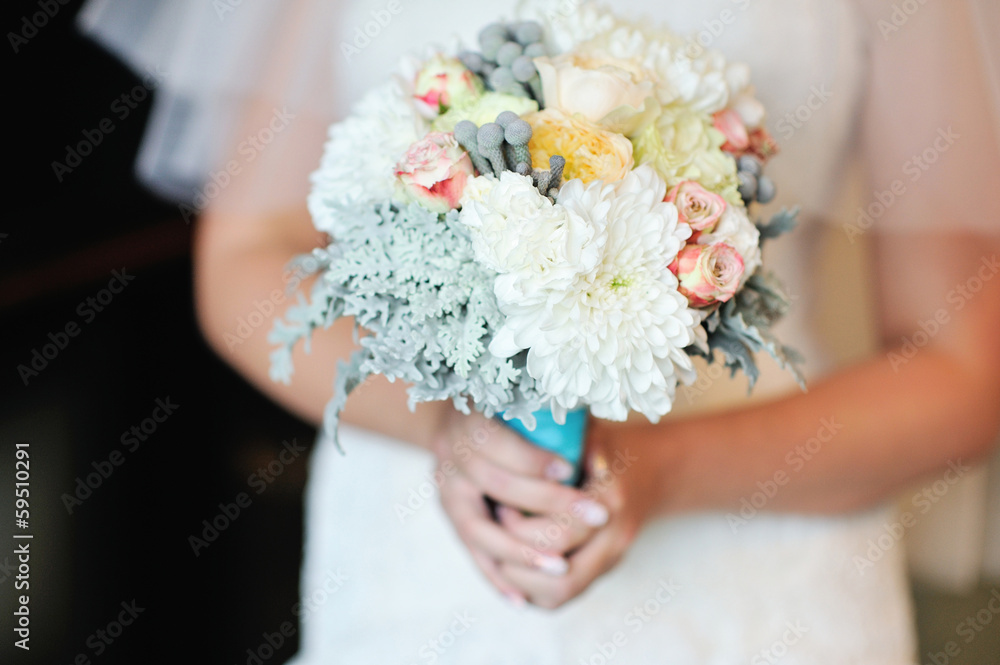 Wedding bouquet of white roses in bride's hands Wedding bouquet of white roses in bride's hands