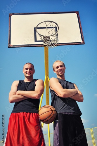 Two basketball players smiling on the court © cirkoglu