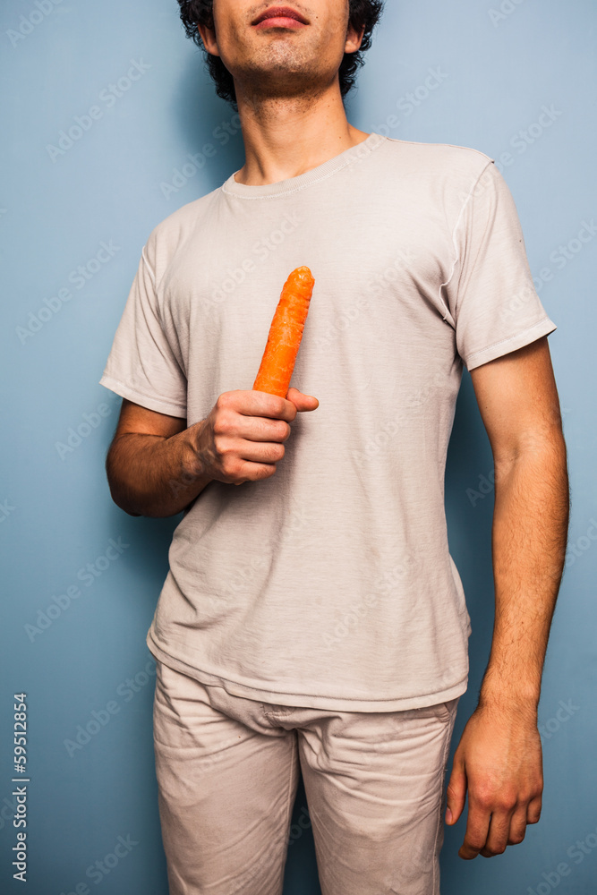 Serious young man with carrot Serious young man with carrot
