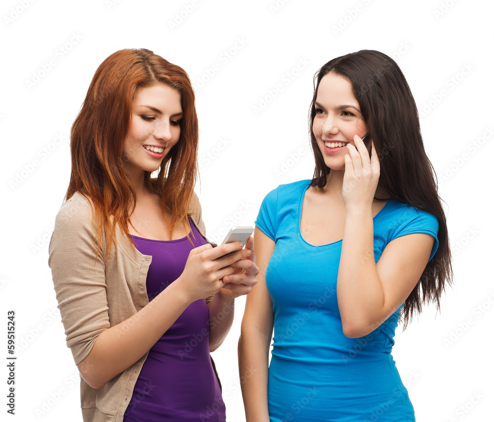 two smiling teenagers with smartphones two smiling teenagers with smartphones