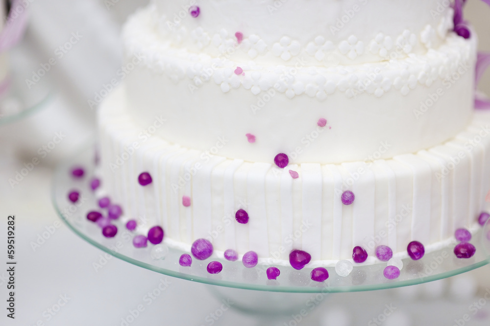 White wedding cake decorated with purple bubbles White wedding cake decorated with purple bubbles