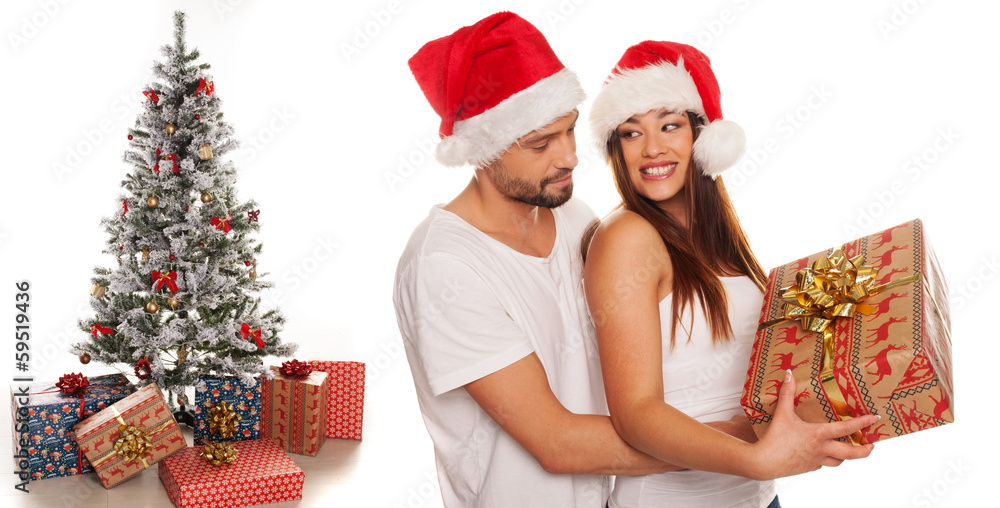 Romantic young man giving his wife an Xmas gift Romantic young man giving his wife an Xmas gift