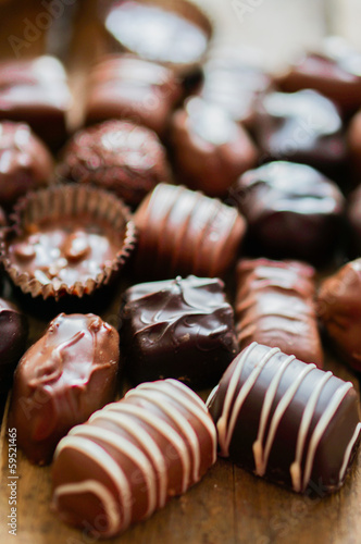 Assorted Chocolate pralines on brown background