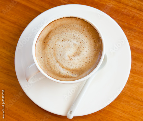A Coffee on the wooden desk, Latte art.