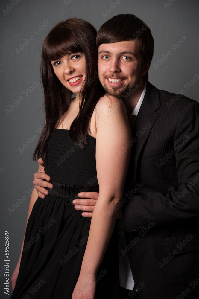 Man and woman smiling on grey background Man and woman smiling on grey background