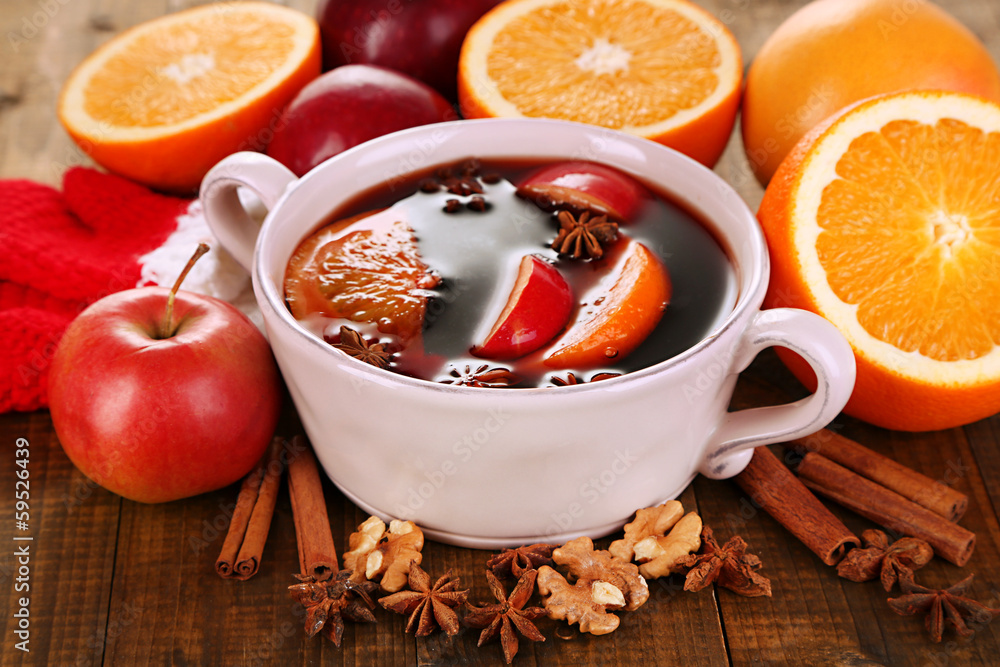 Fragrant mulled wine in pan on wooden table close-up Fragrant mulled wine in pan on wooden table close-up