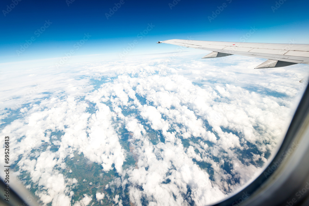 Fototapeta premium Wing aircraft in altitude during flight