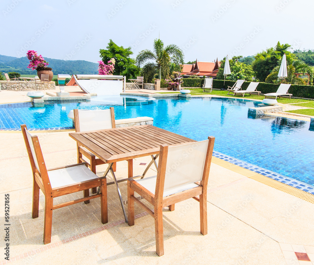 Table and chairs beside the pool