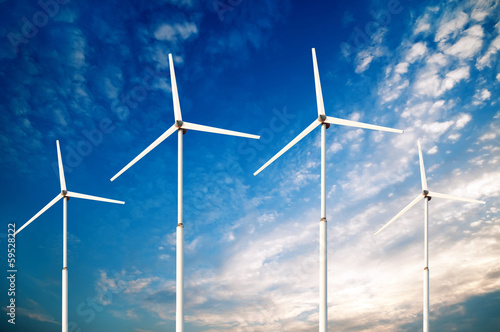 Green renewable energy concept - wind generator turbines in sky