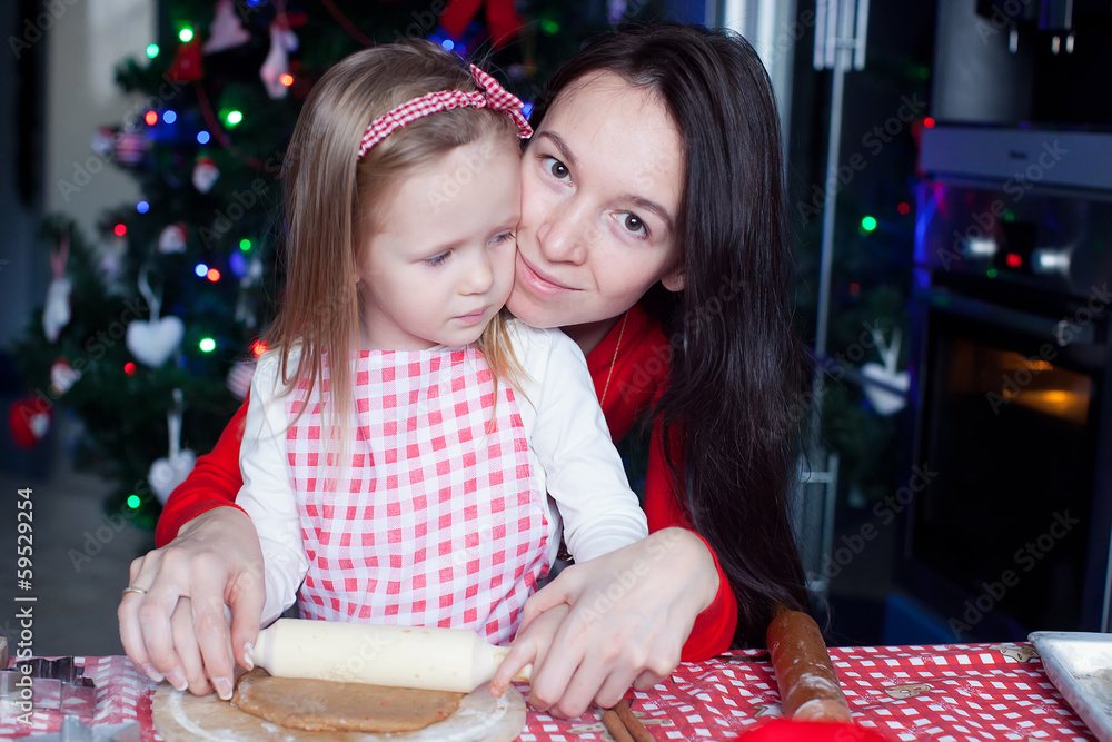 Fototapeta premium Little adorable girl and young mother baking Christmas