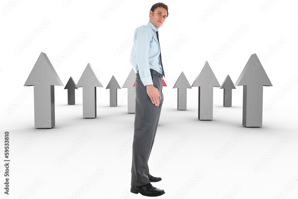 Composite image of serious businessman standing with hand in poc Composite image of serious businessman standing with hand in poc
