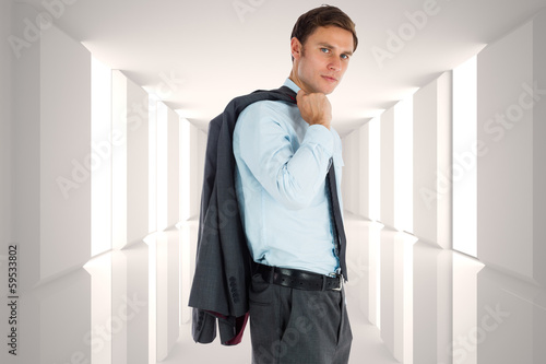 Composite image of serious businessman holding his jacket