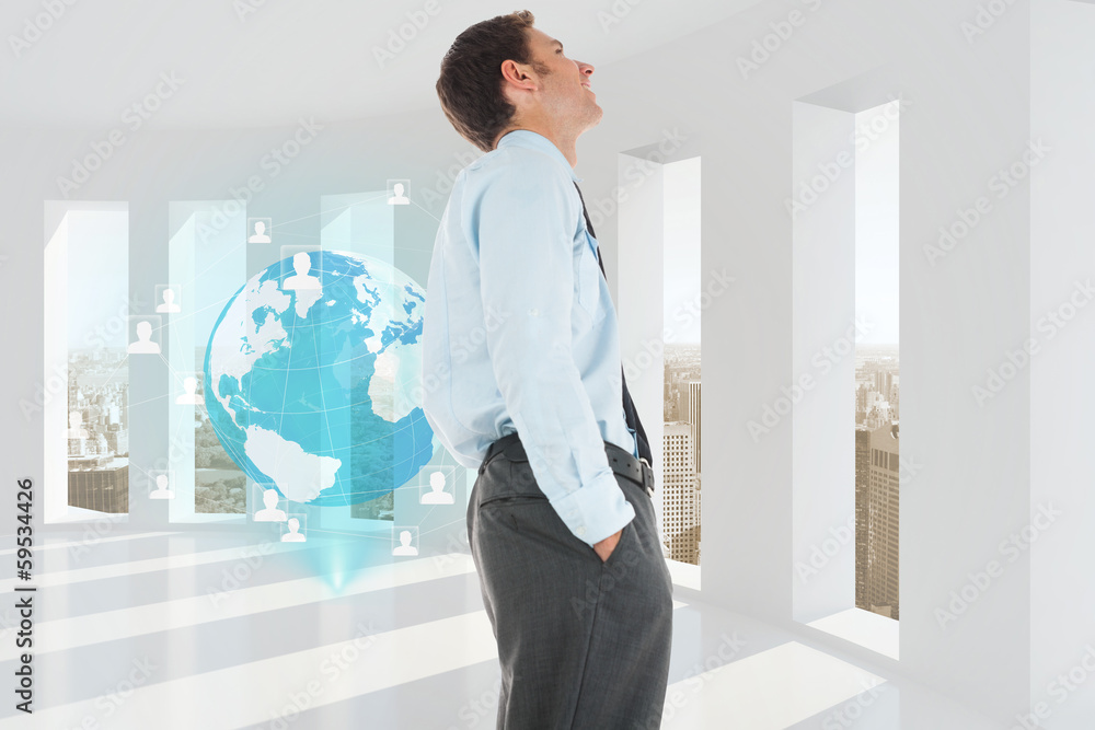 Fototapeta premium Composite image of happy businessman standing with hand in pocke