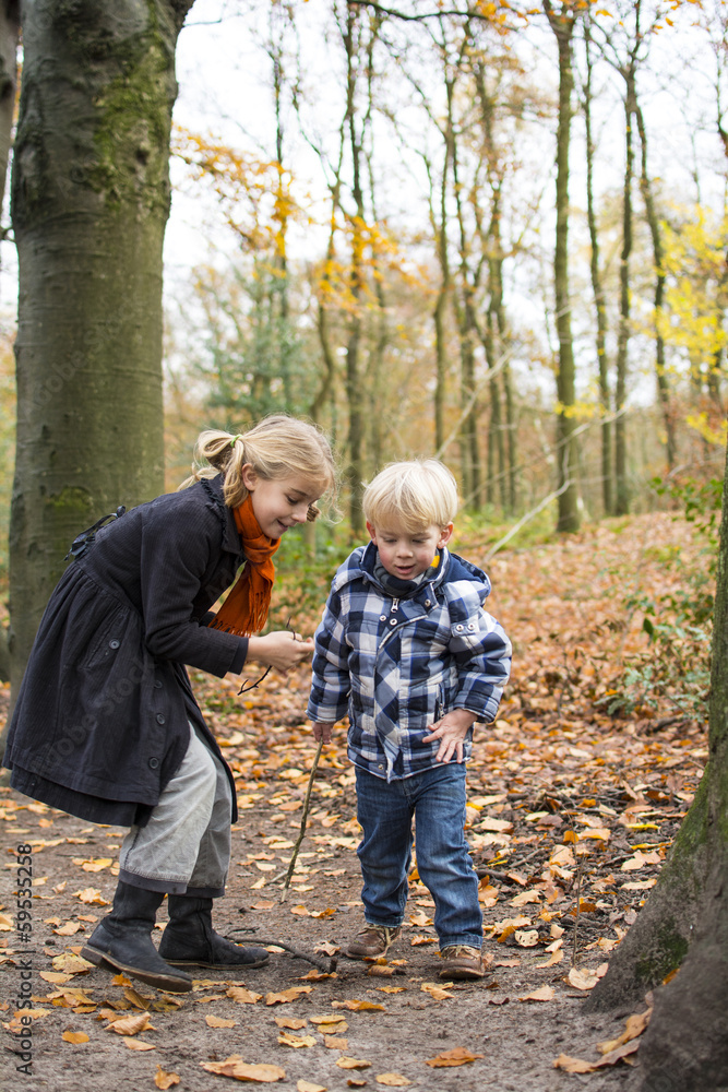 boy and girl playing in forest boy and girl playing in forest