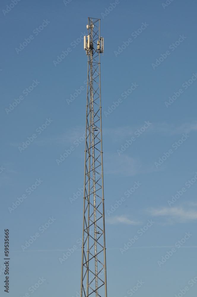 Steel telecommunication tower with antennas over blue sky Steel telecommunication tower with antennas over blue sky
