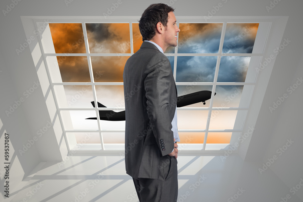 Composite image of smiling businessman with hand on hip Composite image of smiling businessman with hand on hip