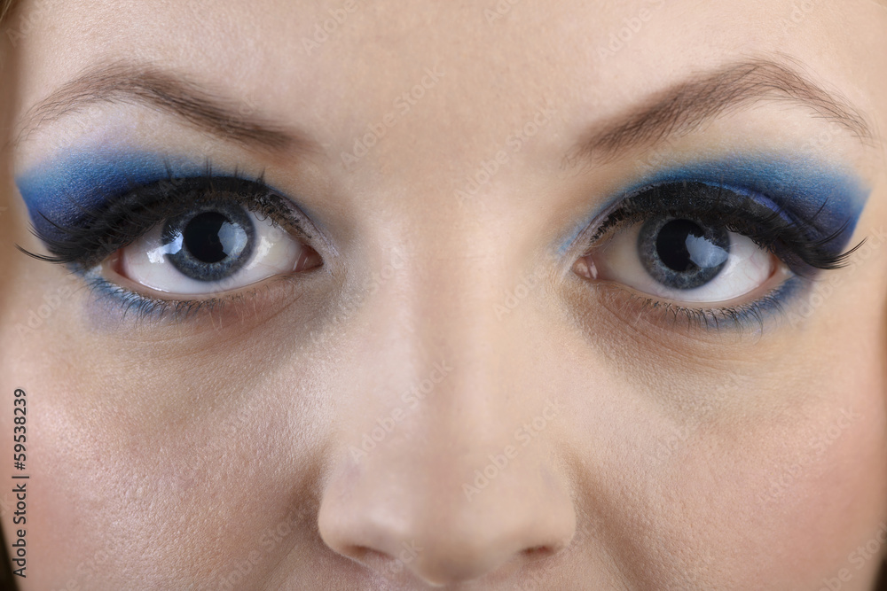 Fototapeta premium close-up portrait of beautiful girl's eye-zone make-up with blue