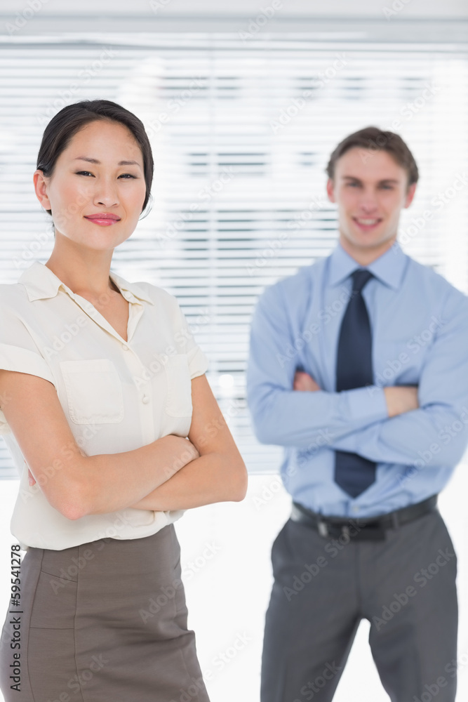 Business colleagues with arms crossed in office Business colleagues with arms crossed in office