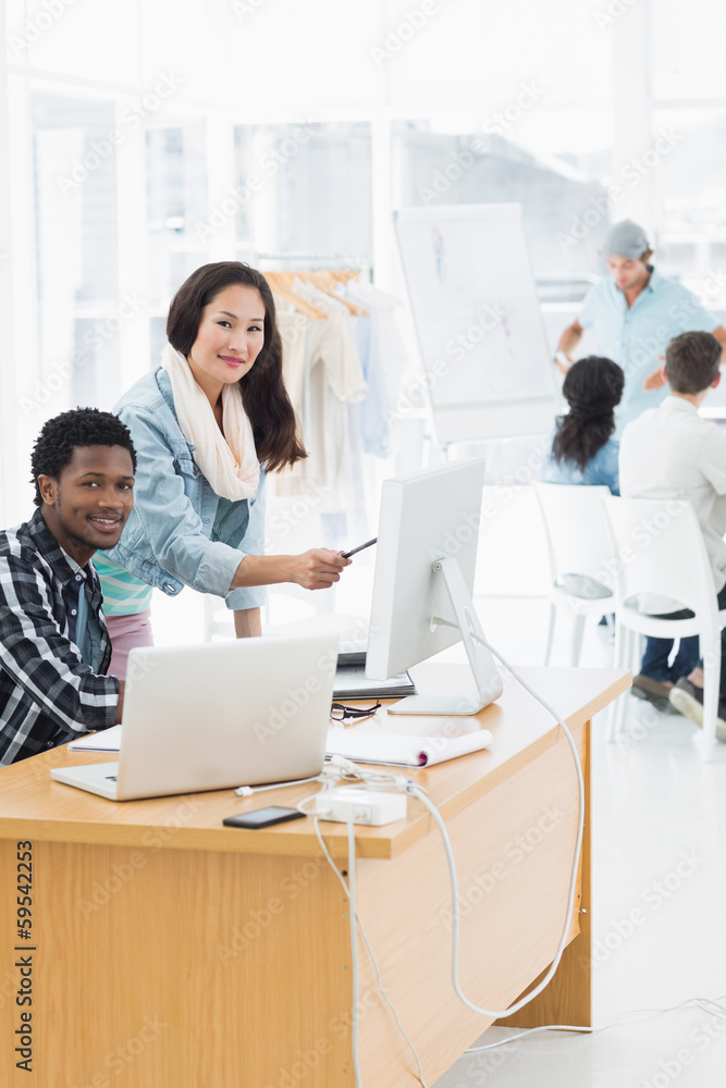 Artists working at desks in creative office