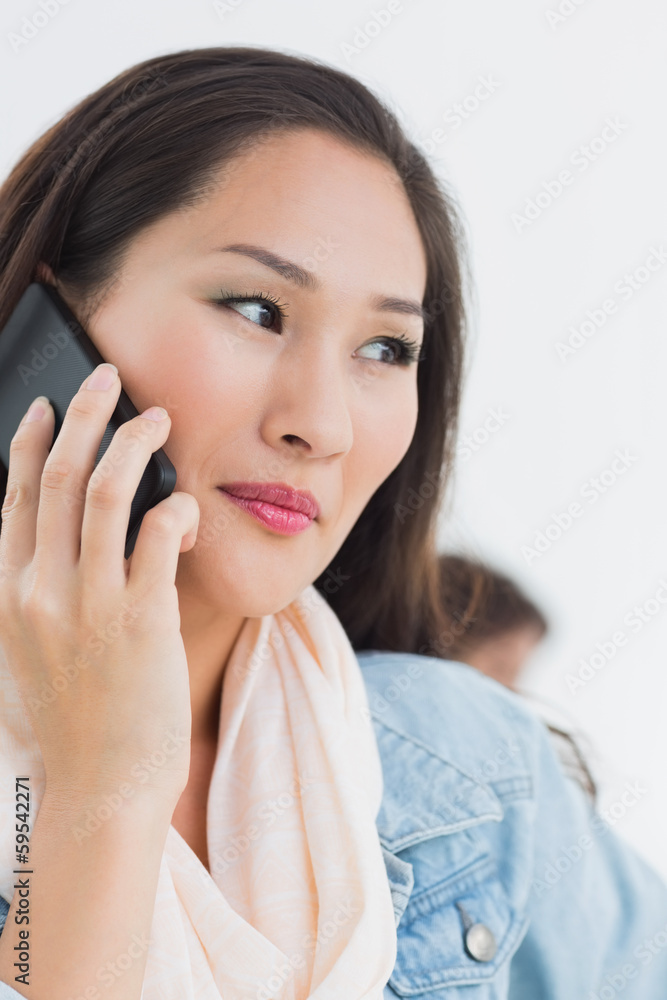 Beautiful casual woman using mobile phone in office