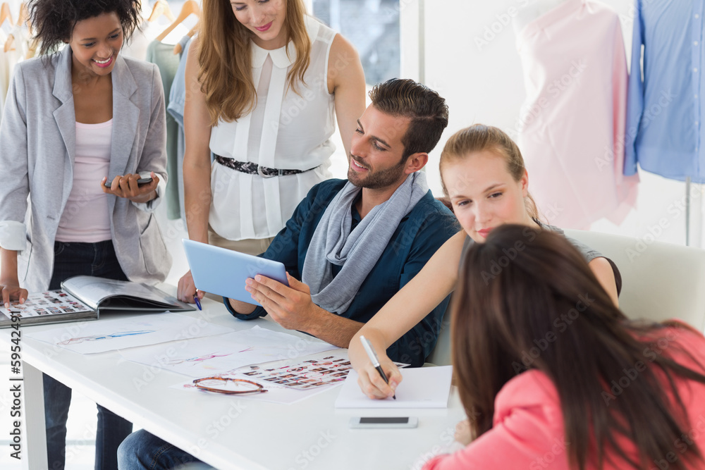Fashion designers discussing designs Fashion designers discussing designs