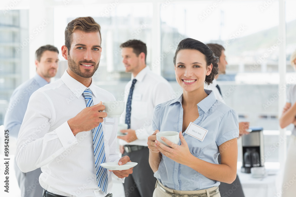 Business colleagues with tea cups during break Business colleagues with tea cups during break