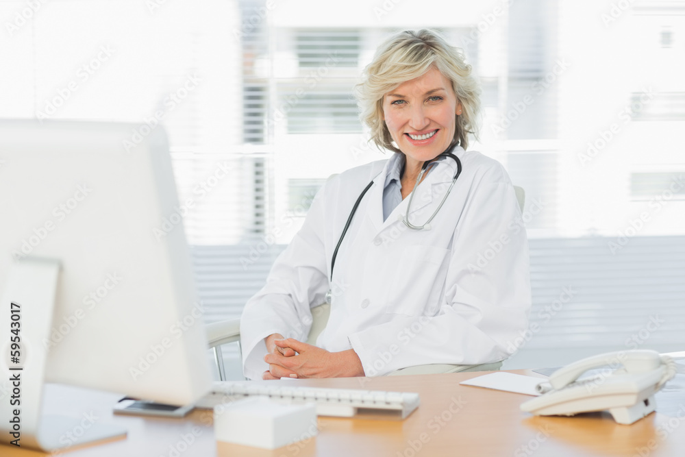 Female doctor sitting with computer at medical office Female doctor sitting with computer at medical office