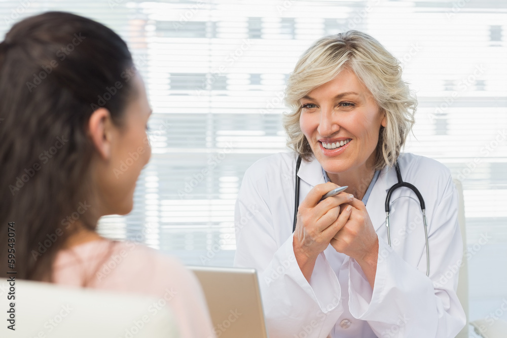 Friendly female doctor in conversation with patient Friendly female doctor in conversation with patient