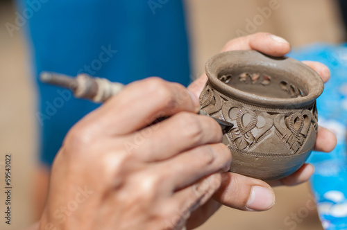Pottery carving in hand