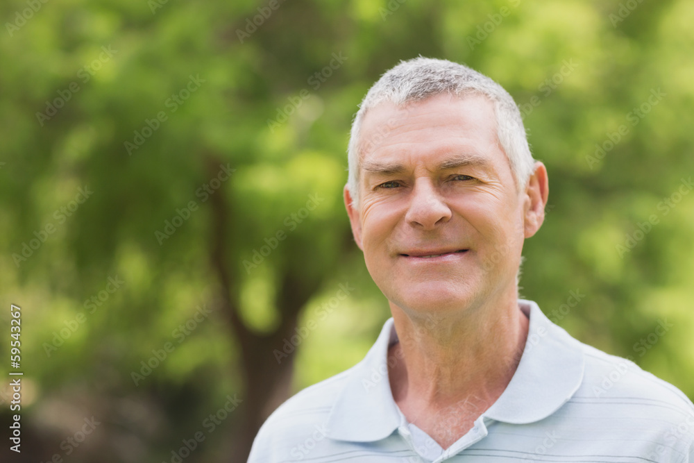 Portrait of a smiling senior man at park Portrait of a smiling senior man at park