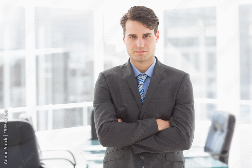 Handsome businessman leaning on board room table Handsome businessman leaning on board room table