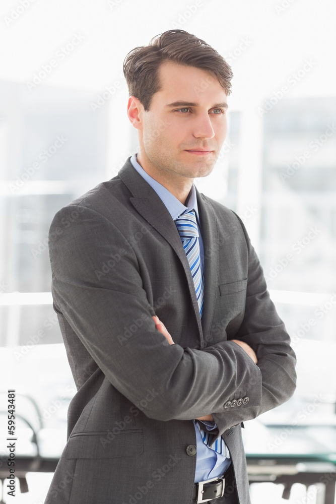 Handsome focused businessman with arms crossed Handsome focused businessman with arms crossed
