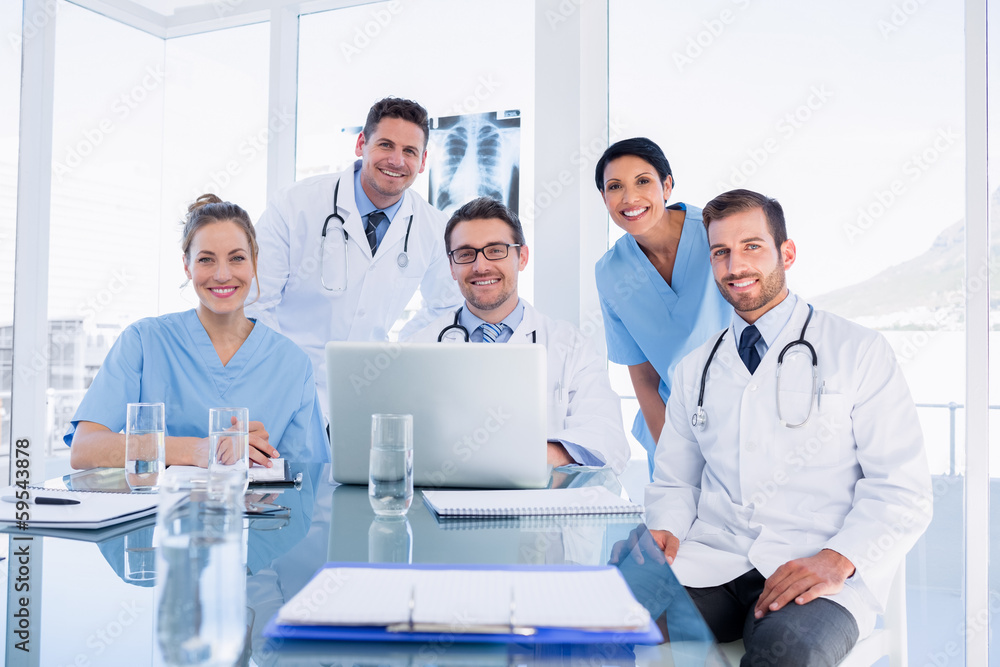 Fototapeta premium Happy medical team using laptop together