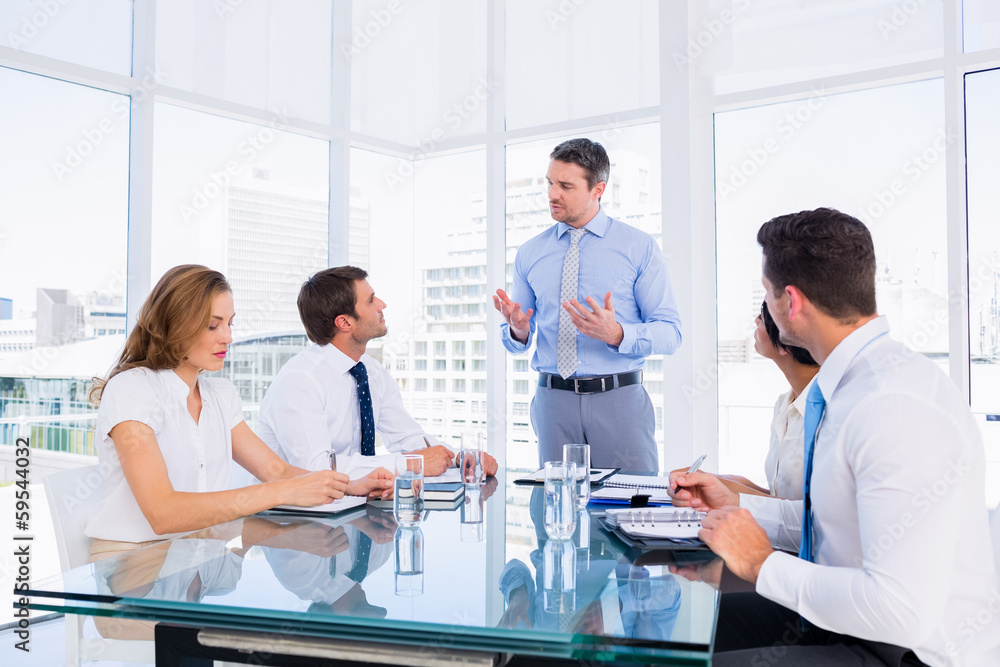 Fototapeta premium Executives sitting around conference table
