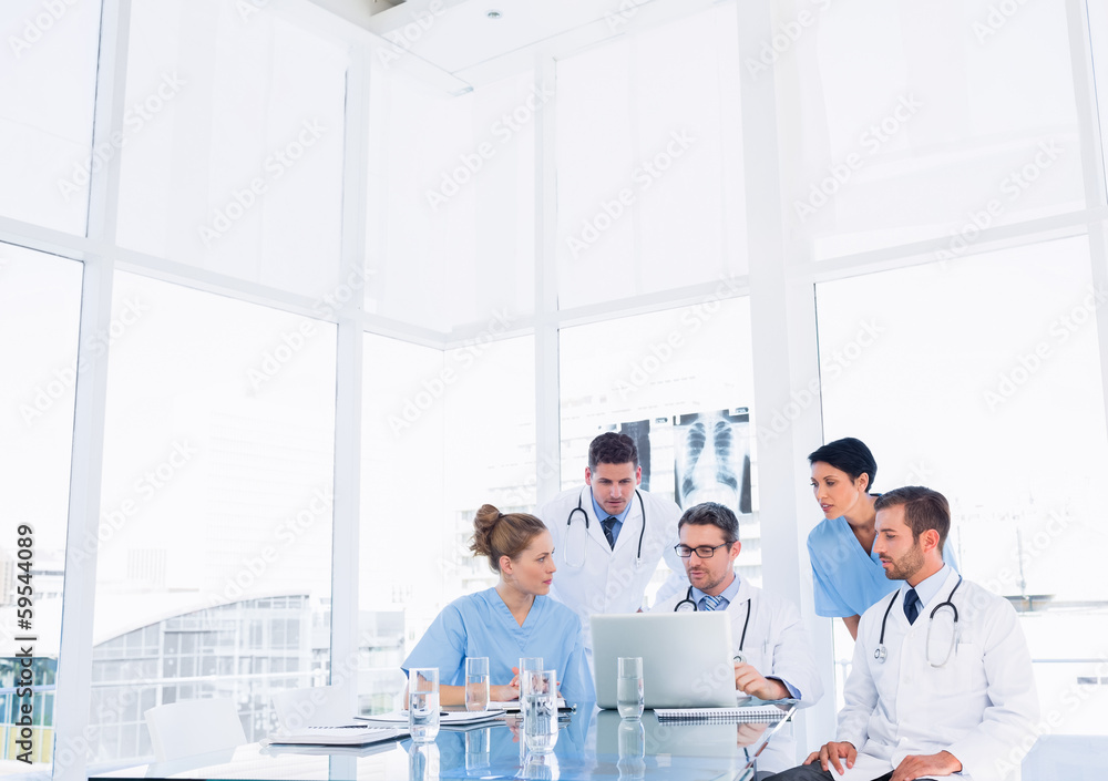Concentrated medical team using laptop Concentrated medical team using laptop