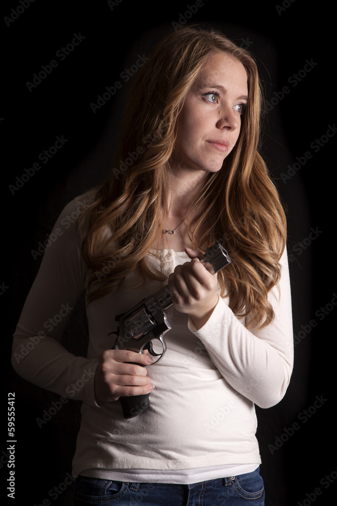 woman in low light gun look side