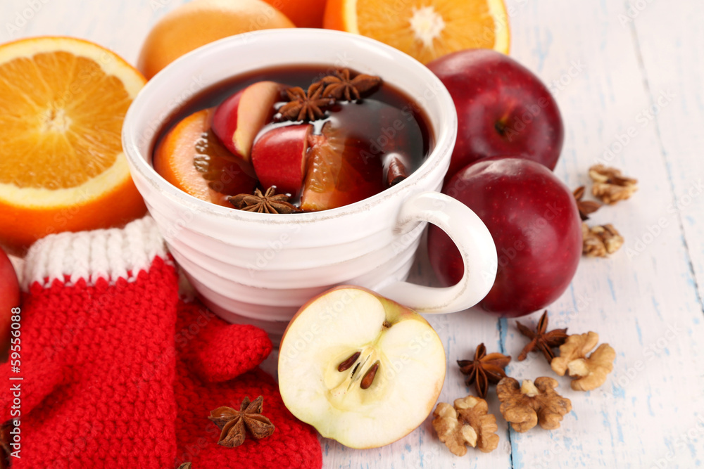 Fragrant mulled wine in bowl on wooden table close-up Fragrant mulled wine in bowl on wooden table close-up