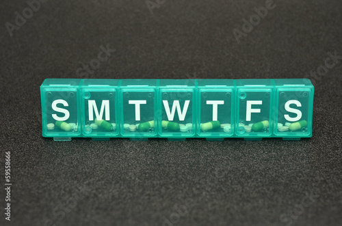 Konstfotografi 7 day prescription pill organizer on dark background