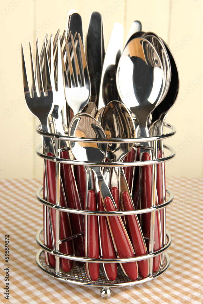 Knives, forks and spoons in metal stand Knives, forks and spoons in metal stand
