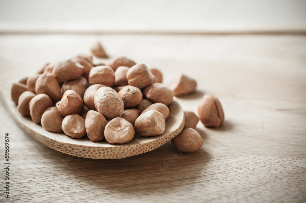 Peanuts closeup on wood ladle Peanuts closeup on wood ladle