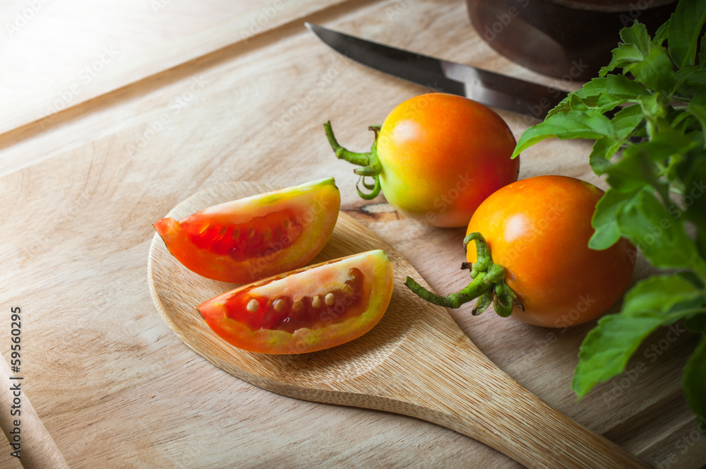 tomatoes slice on wood ladle closeup tomatoes slice on wood ladle closeup