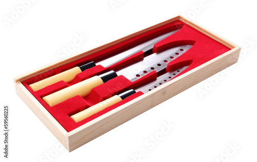 Set of kitchen knives in wooden box isolated on white