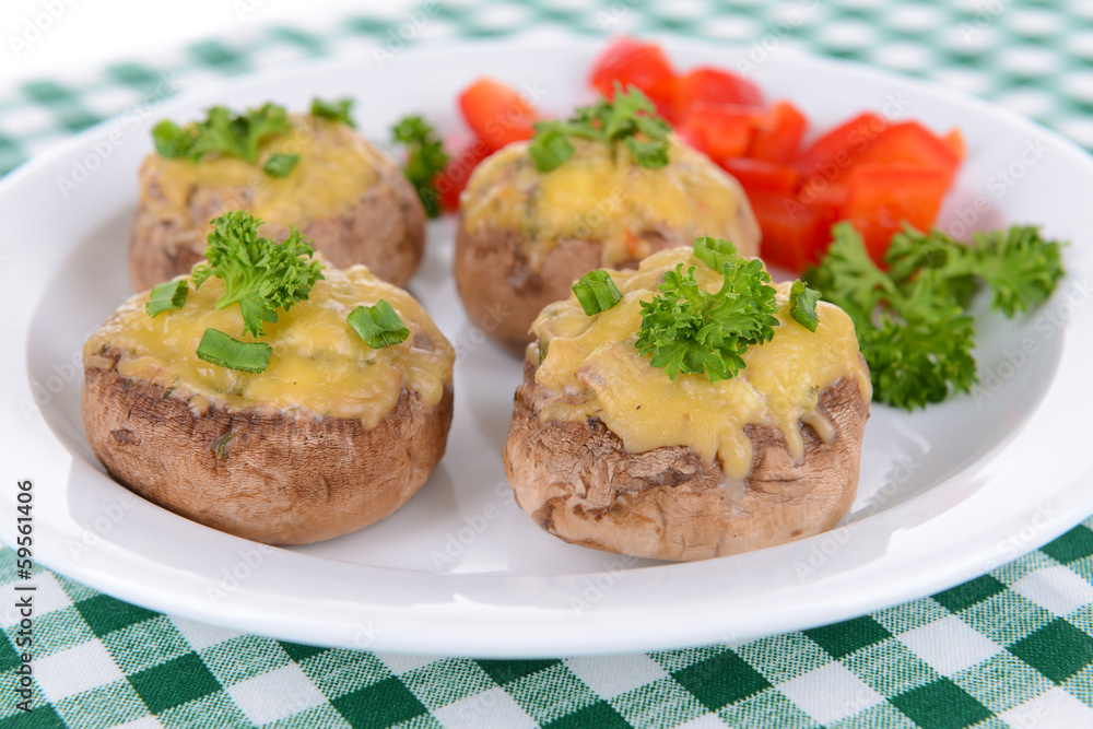 Stuffed mushrooms on plate on table close-up Stuffed mushrooms on plate on table close-up