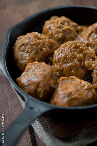 Close-up of meat balls in cast-iron pan, vertical shot