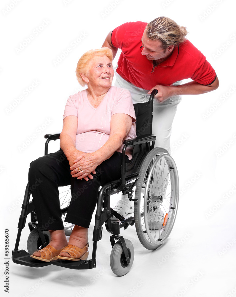 Elderly paraplegic woman in a wheelchair and her male nurse. Elderly paraplegic woman in a wheelchair and her male nurse.