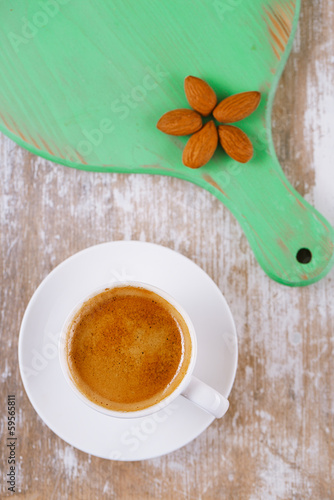 espresso coffee and almonds on old rustic table, shallow dof photo