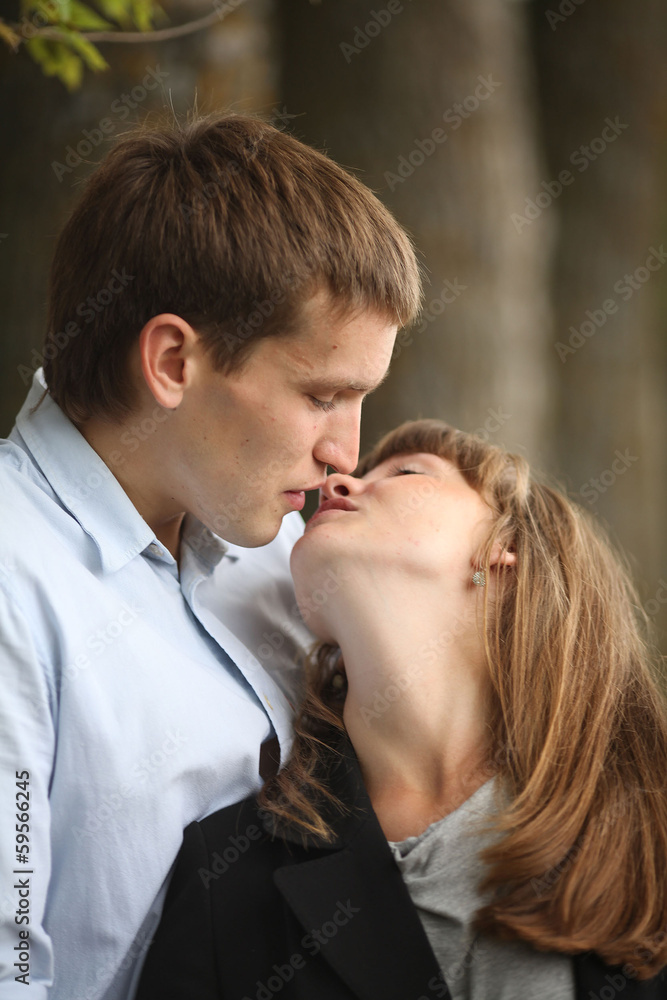 embracing and kissing young guy and girl on nature embracing and kissing young guy and girl on nature