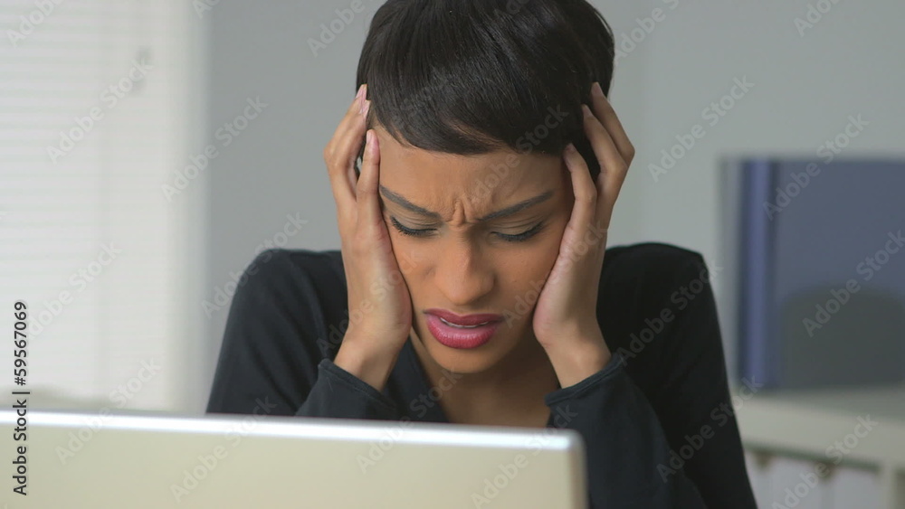 African American business woman expressing frustration at work African American business woman expressing frustration at work