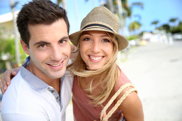 Portrait of cheerful couple of tourists