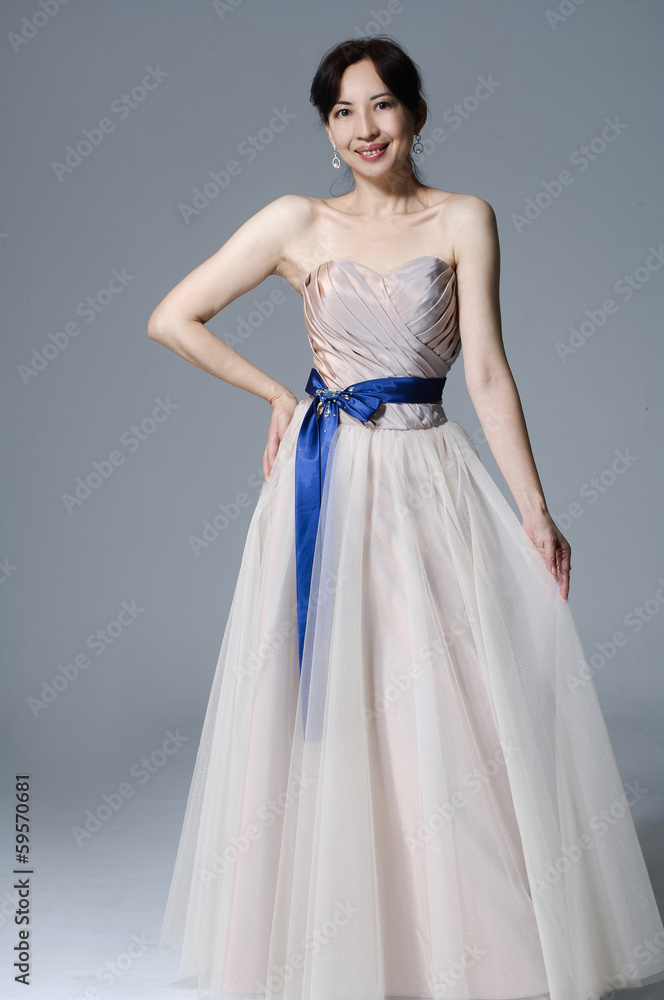 beautiful smiling girl in a white wedding dress posing